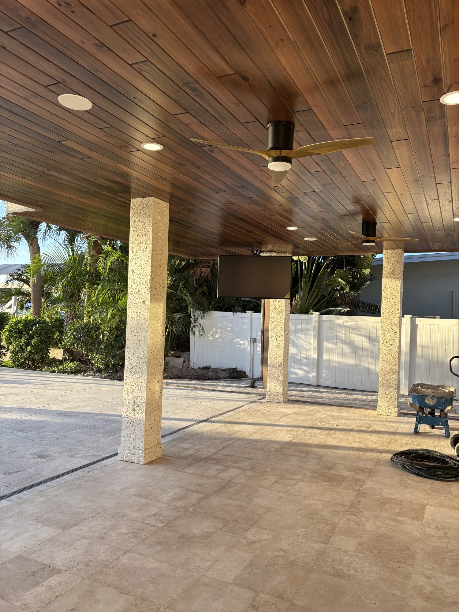Covered lanai with wood ceiling, ceiling fans and recessed lighting in Tampa waterfront home by Dim and Dimmer Electric
