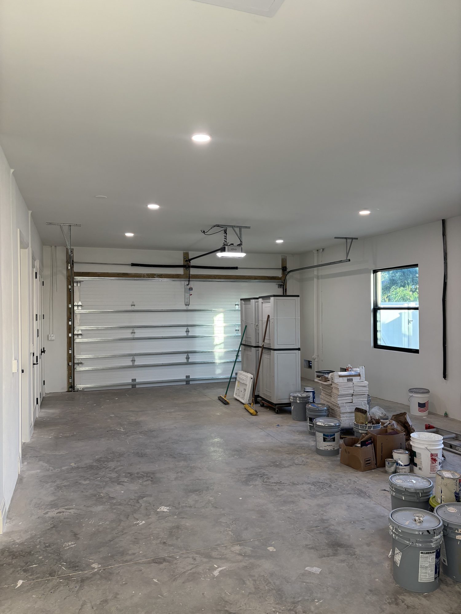 Garage with recessed lighting and opener wiring in Tampa waterfront custom home by Dim and Dimmer Electric