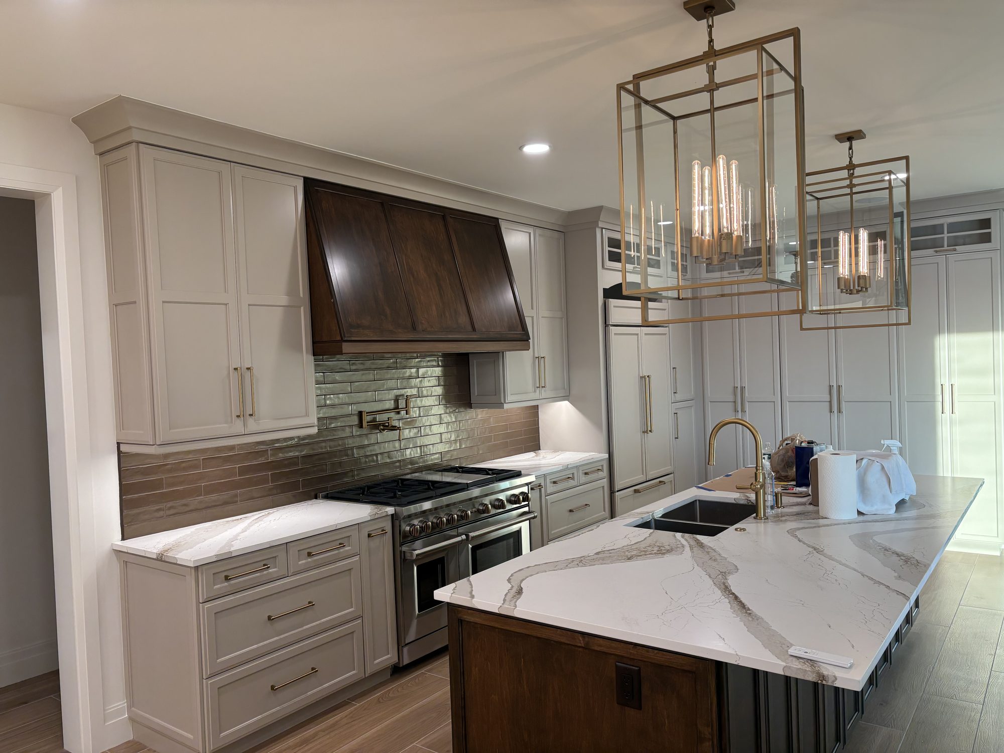 Custom kitchen with pendant lighting over island and under cabinet LED in Tampa waterfront home by Dim and Dimmer Electric