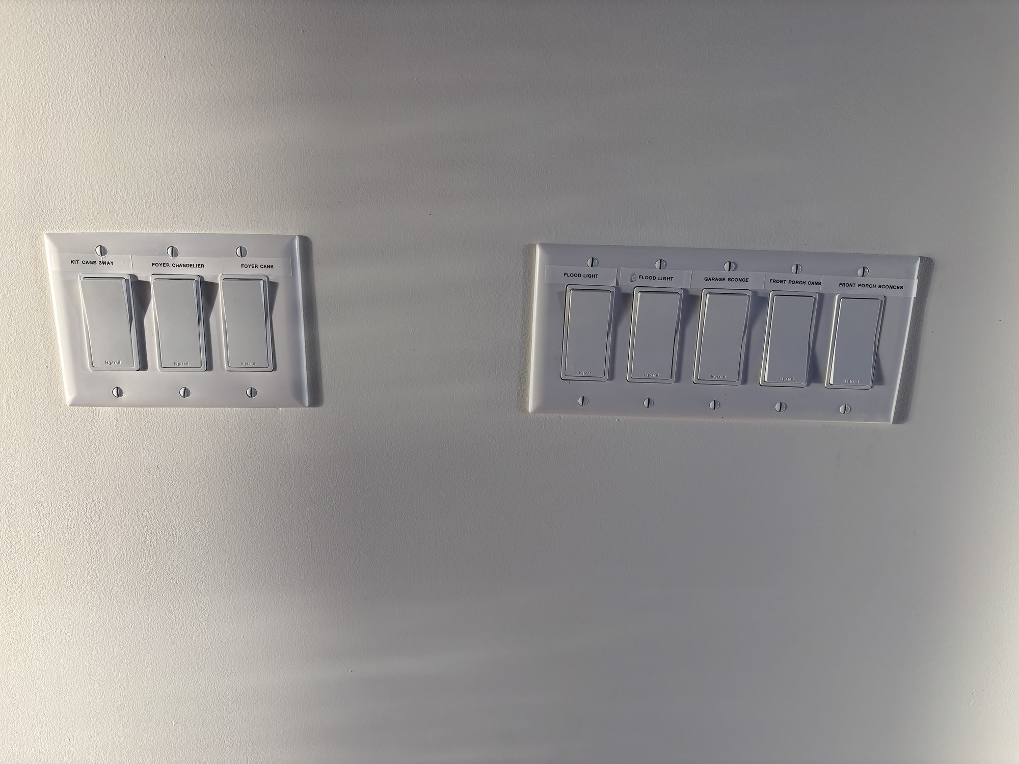 Labeled multi gang switch banks from whole house wiring in Tampa custom home by Dim and Dimmer Electric